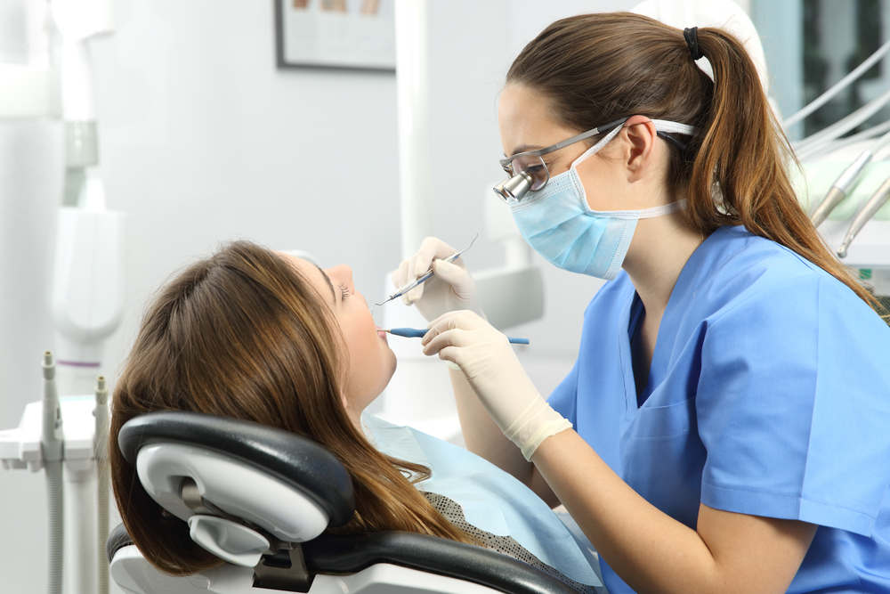 dental hygienist performing a check
