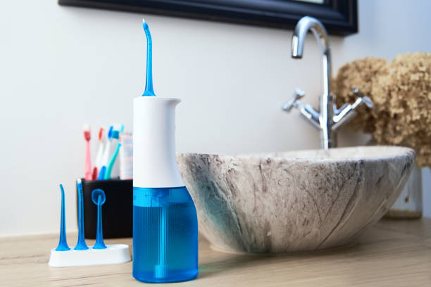 A waterflosser being incorporated as a regular dental hygiene practice.